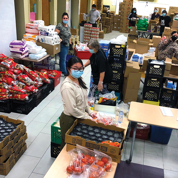Image of volunteers preparing food hampers at a food bank